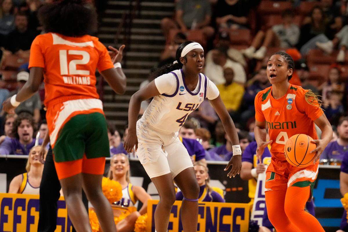 Mar 26, 2023; Greenville, SC, USA; Miami Hurricanes guard Jasmyne Roberts (4) looks to guard Ja’Leah Williams (12) defended by LSU Lady Tigers guard Flau’jae Johnson (4) during the NCAA Women’s Tournament at Bon Secours Wellness Arena. Mandatory Credit: Jim Dedmon-USA TODAY Sports