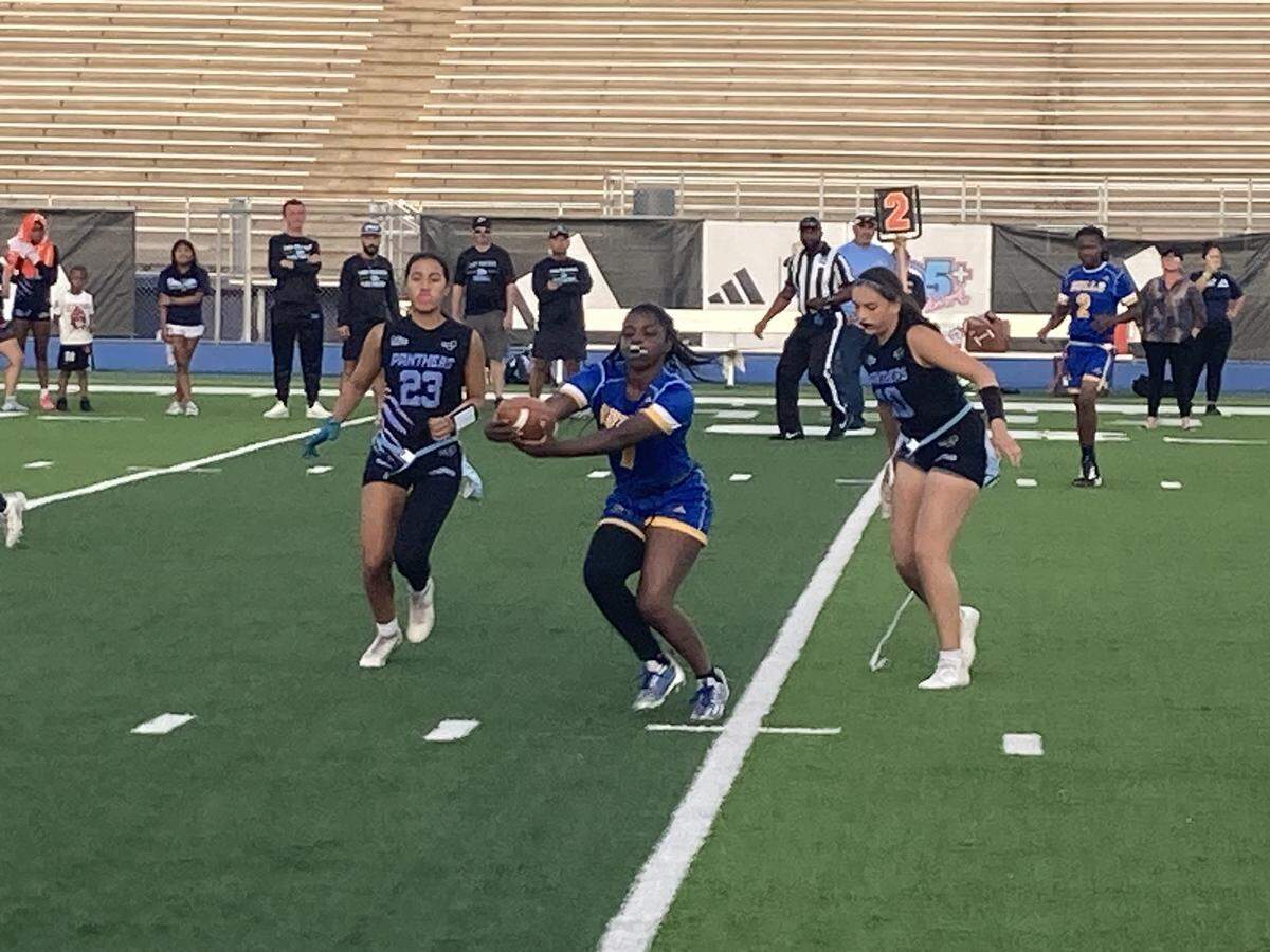 Northwestern’s Zahara Leaks stretches for more yardage against Palmetto defenders during Monday’s GMAC flag football championship game at Traz Powell Stadium in Miami, Fla.