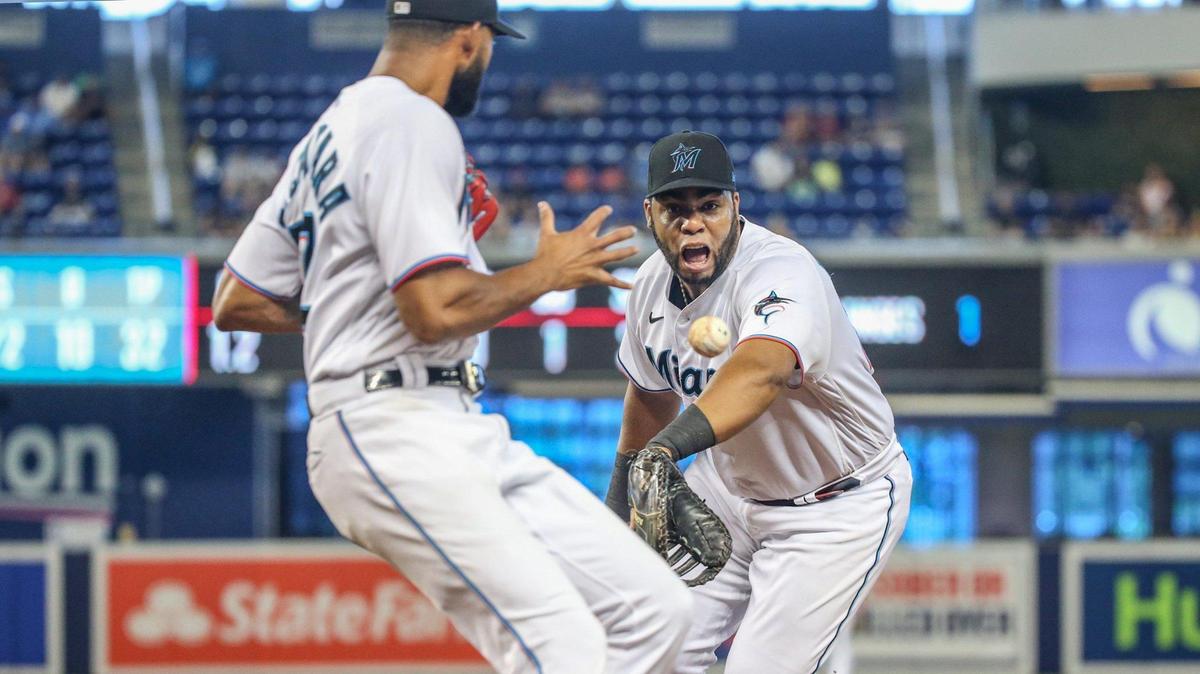 Miami Marlins first baseman Jesus Aguilar (24) tosses the ball to pitcher Sandy Alcantara (22) to tag out Los Angeles Dodgers second baseman Zach McKinstry (8) at first base in the second inning during baseball game at loanDepot park in Miami on Thursday, July 8, 2021.
