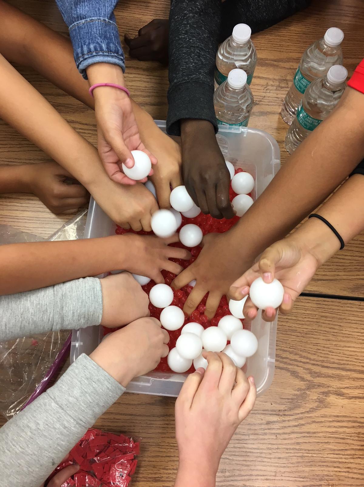 A child-life specialist used ping-pong balls, representing white blood cells, to help Amanda Aiello’s fifth-grade classmates understand what happened to her.