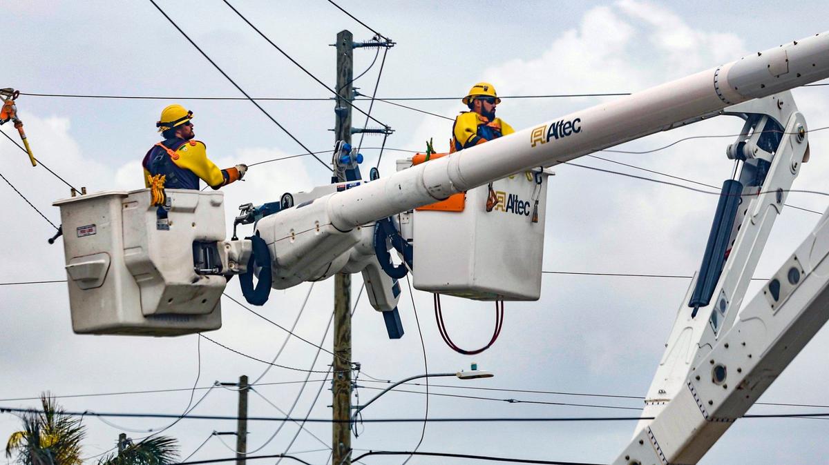 Utility workers repair the power lines damaged during Hurricane Milton in Venice, Florida, on Friday, October 11, 2024.