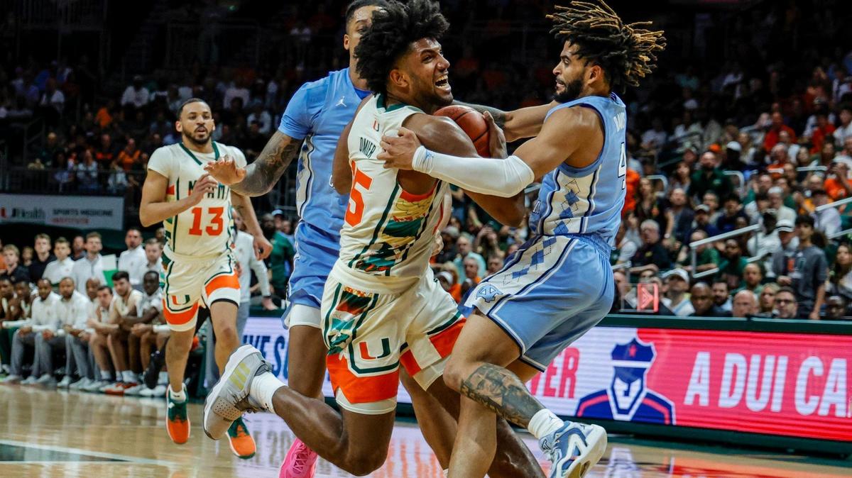 Miami Hurricanes forward Norchad Omier (15) battles North Carolina Tar Heels guard RJ Davis (4) in the paint in the first half at the Watsco Center in Coral Gables, FL on Saturday, February 10, 2024.
