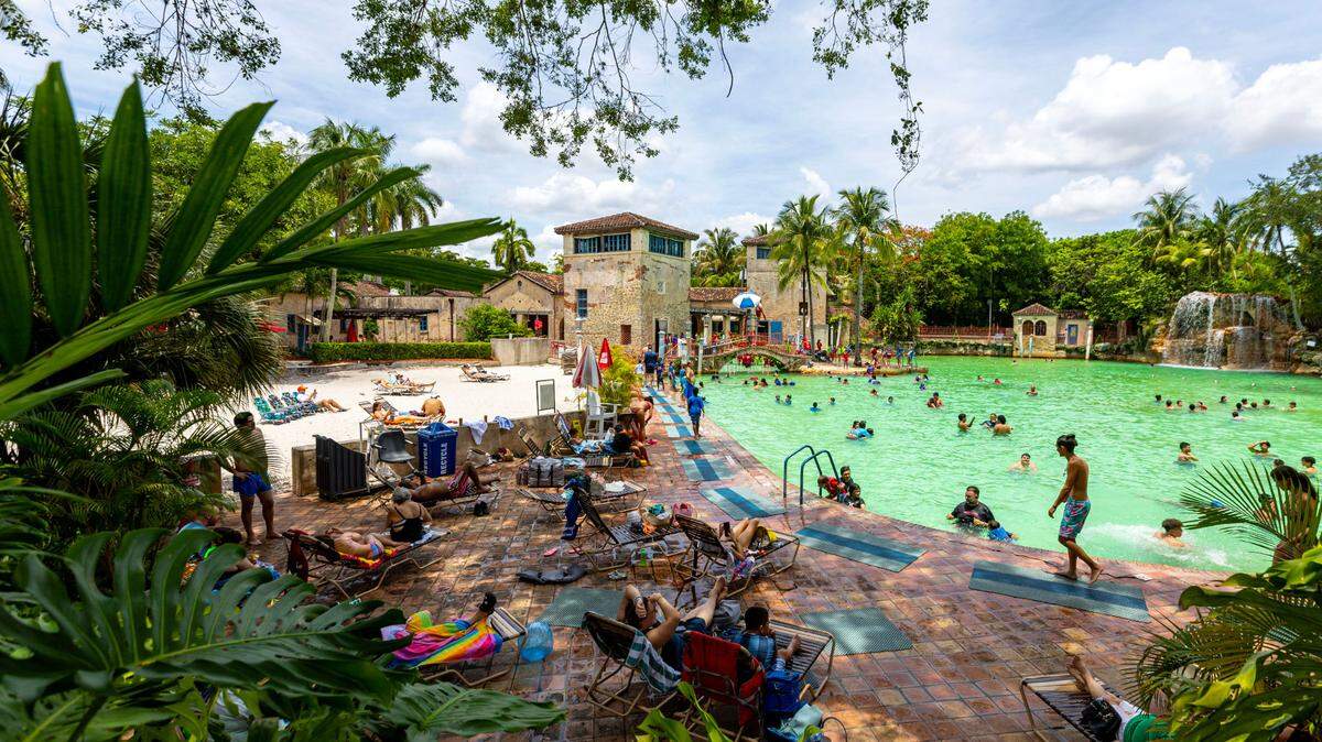 People socialize and swim at Venetian Pool on Wednesday, June 28, 2023, in Coral Gables, Florida.