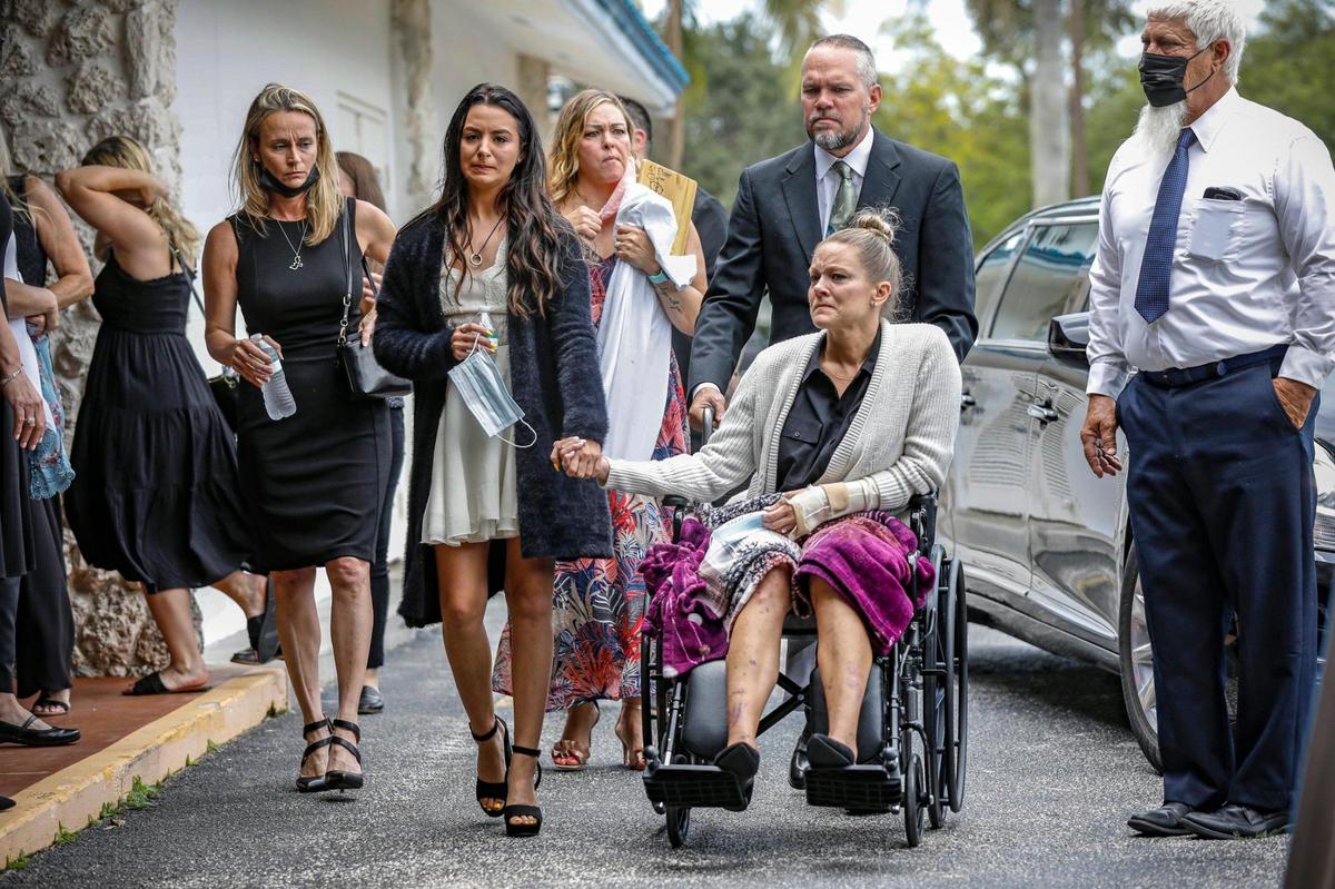 Surfside condominium collapse victim Edgar Gonzalez’s daughter, Tayler Scheinhaus, and his wife, Angela Gonzalez, hold hands as they arrive for his funeral in Palmetto Bay. Angela and daughter Deven suffered major injuries but survived.