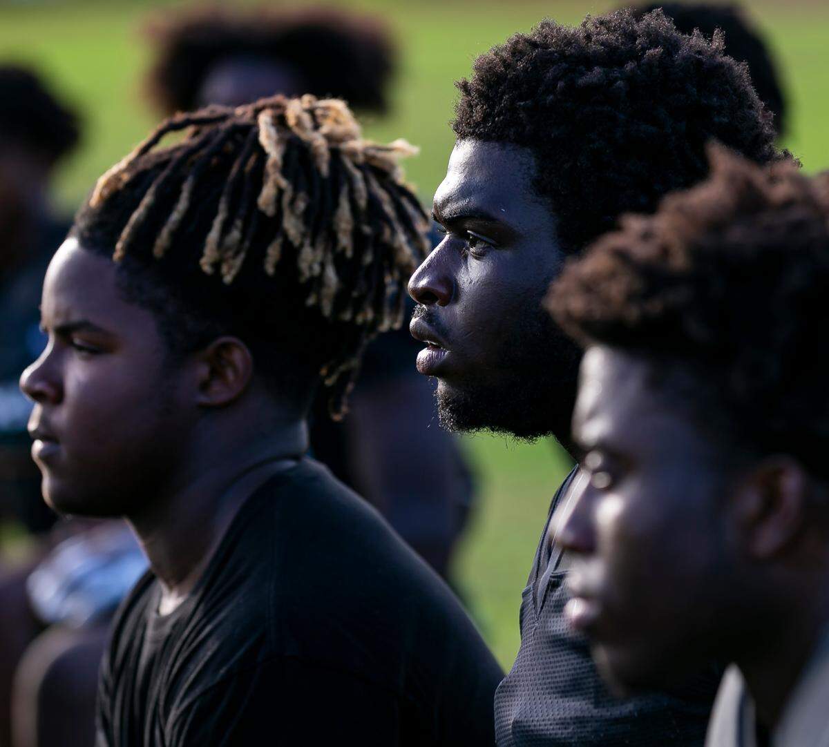 Miami Central football players listen to head coach Roland Smith (not photographed) during a preseason practice at their school’s field in Miami’s West Little River neighborhood on Thursday, August 5, 2021.