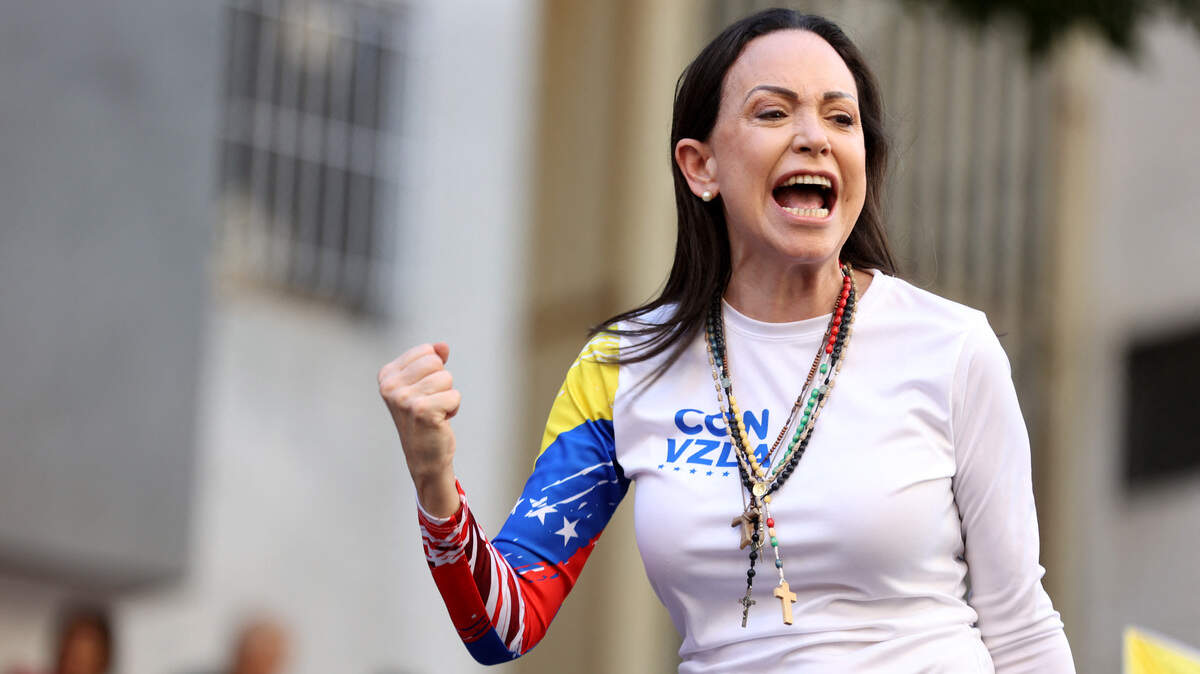 Venezuelan opposition leader Maria Corina Machado gestures as she addresses her supporters during a protest called by the opposition on the eve of the presidential inauguration in 2025.