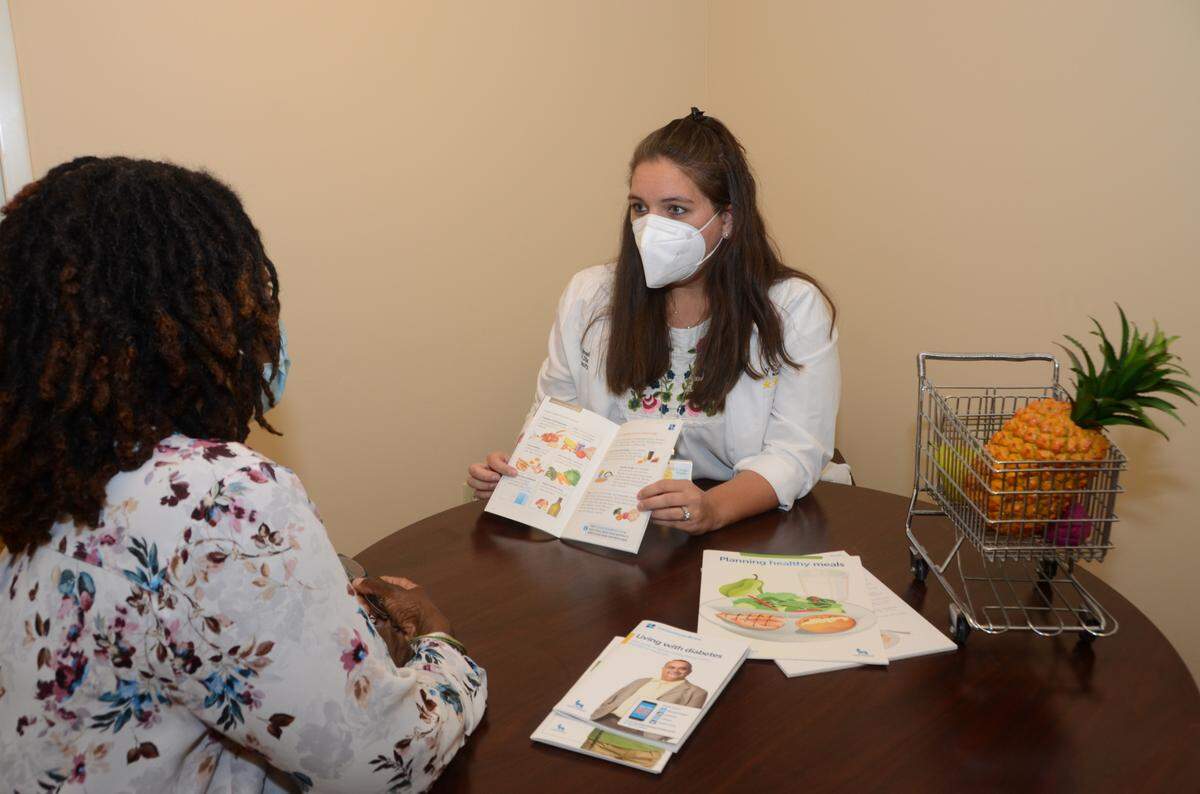 Kristen Schroeder-Brown, a registered nurse and certified diabetic educator at Holy Cross Health in Fort Lauderdale, consults with a patient.