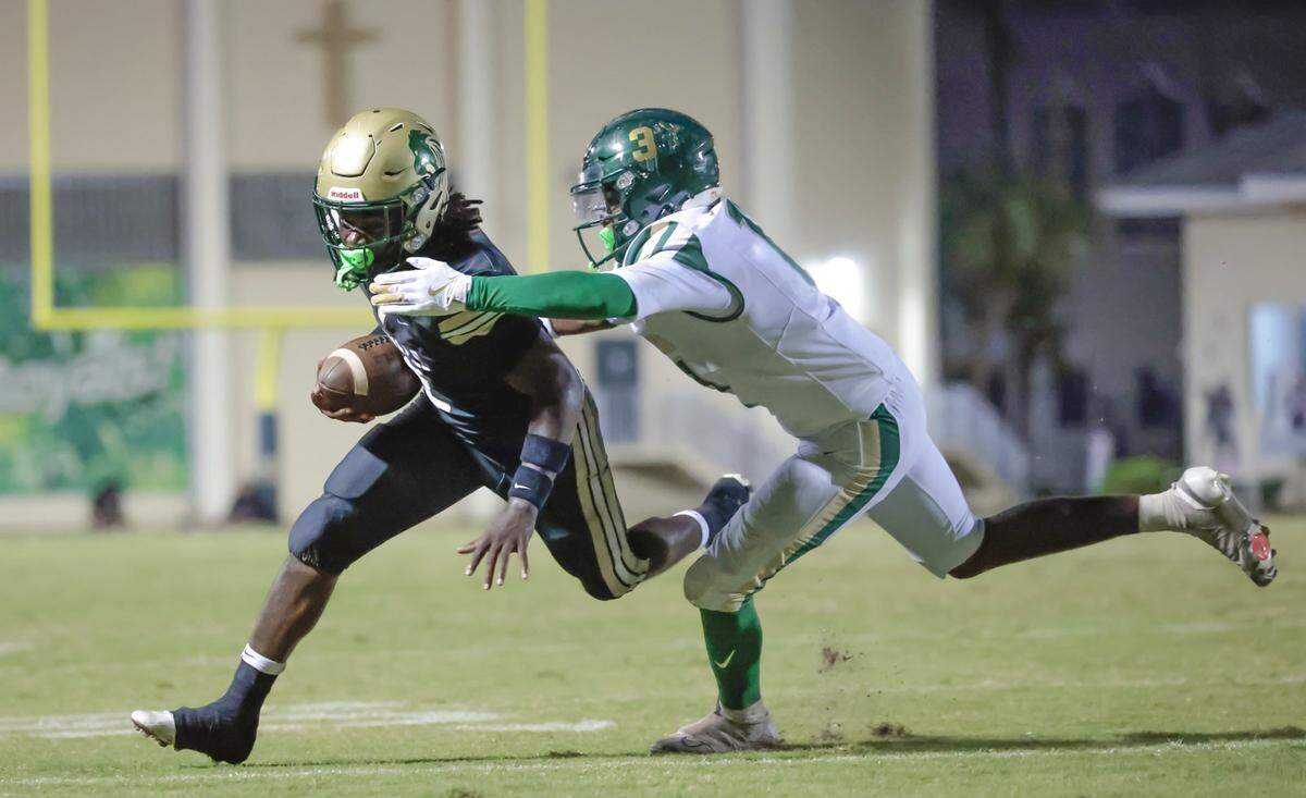 Immaculata-La Salle High School's running back Adrian Cox (2) carries the ball towards the one yard line as Mater Academy's linebacker Victor Latimore (11) gives chase at Immaculata-La Salle High School in Miami, FL, on Friday, October 24, 2025.