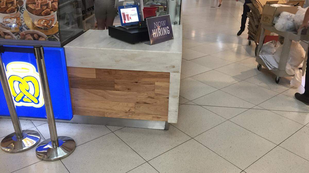 A help-wanted sign in Dolphin Mall is indicative of the demand for labor as unemployment in South Florida hits record lows.