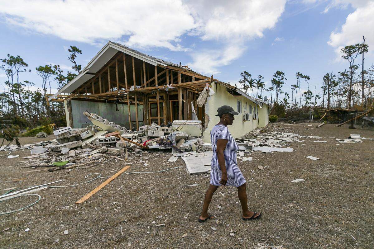 Donalee Smith, 61, a seamstress, walks through the rubble of her sister’s house in Freeport, Bahamas on Friday, Sept. 6, 2019. Thousands of Bahamians fled Freeport after Hurricane Dorian decimated Grand Bahama Island in early September.