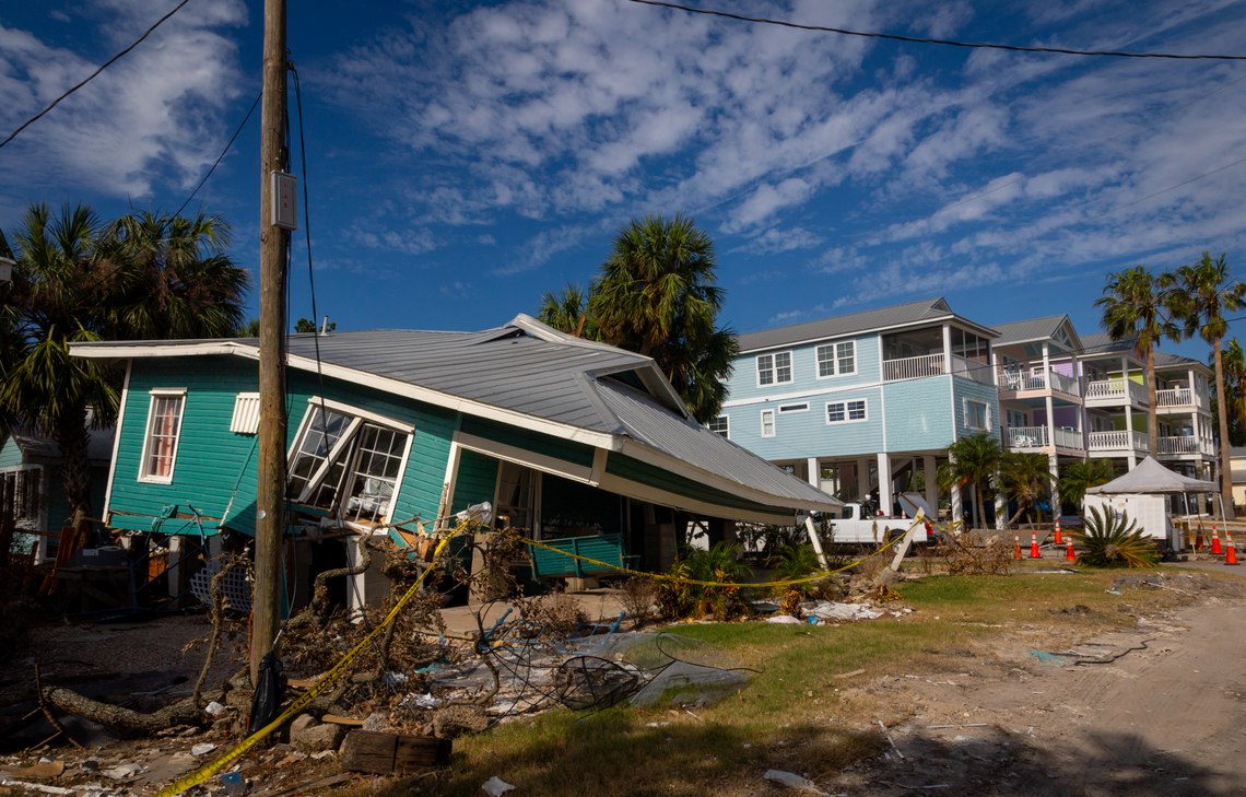 A home lifted a few feet off the ground topples to the ground next to a home on higher stilts in Cedar Key. Just some of damage along Florida’s Gulf Coast after Hurricane Helene.