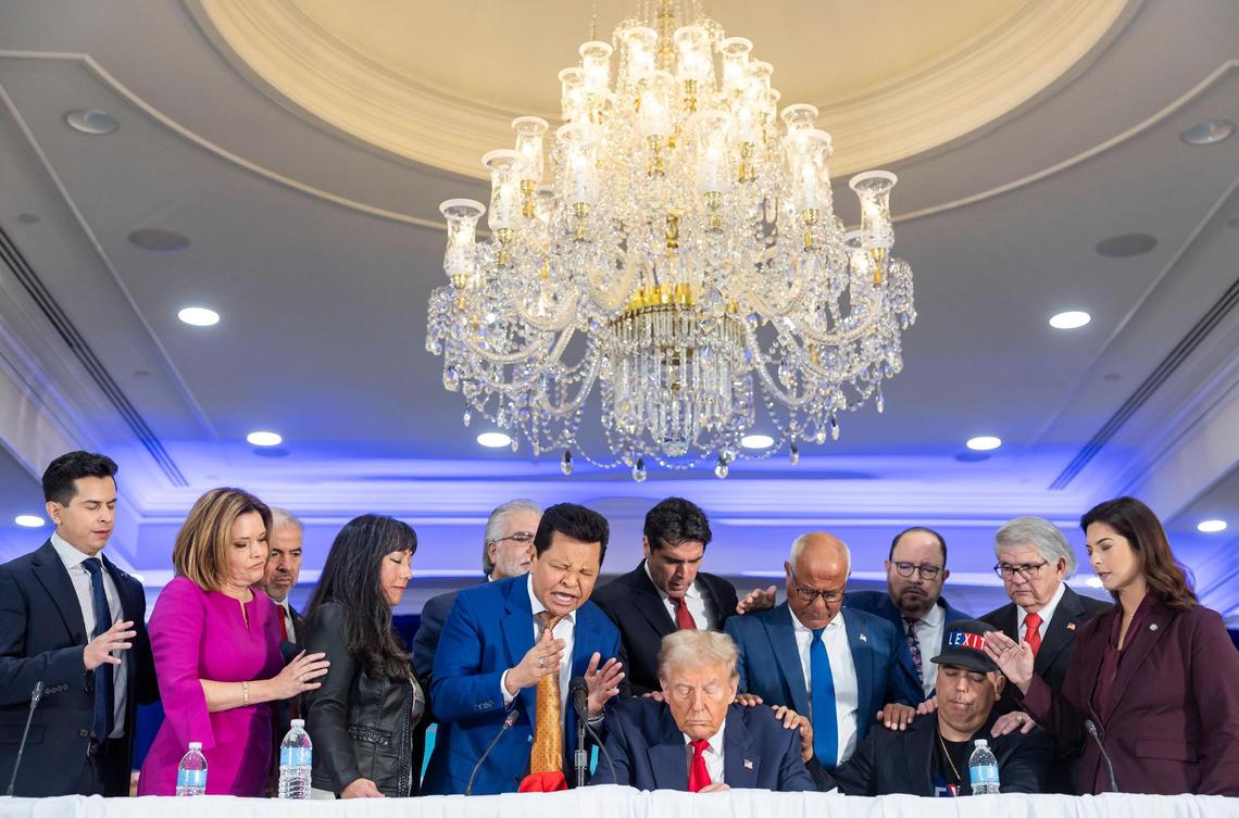 Miami megachurch pastor and evangelical Guillermo Maldonado, center-left, leads a prayer after Republican presidential candidate and former President Donald Trump spoke during a roundtable discussion with local Latino leaders at Trump National Doral Miami on Tuesday, Oct. 22, 2024, in Doral, Fla.