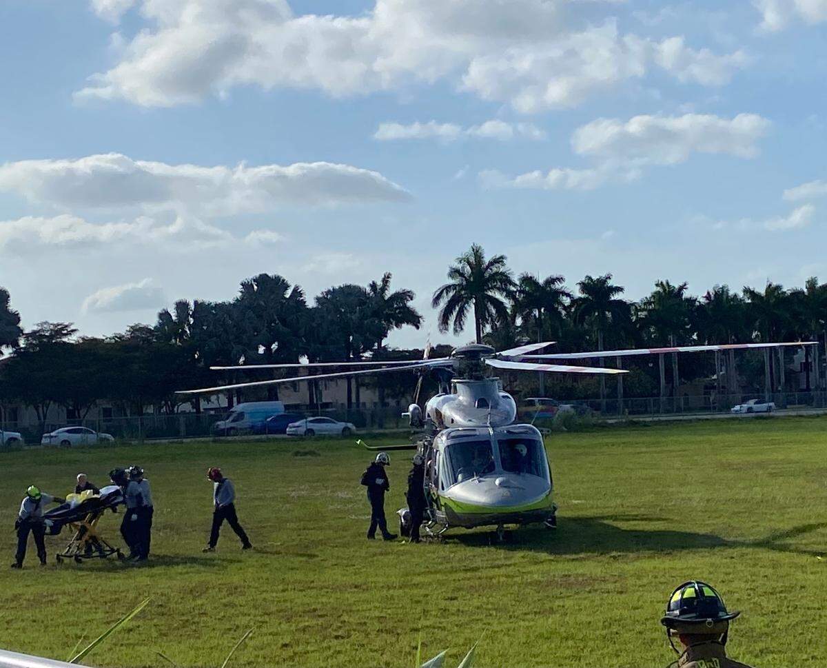 Miami-Dade Fire Rescue paramedics prepare to place a shooting victim into a helicopter ambulance at a field at Southwest 240th Street and 112th Avenue near Princeton Monday, April 7, 2025.