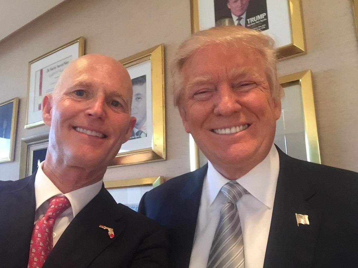 Florida Gov. Rick Scott poses for a selfie with President-elect Donald Trump during their meeting at Trump Tower in New York in November 2016.