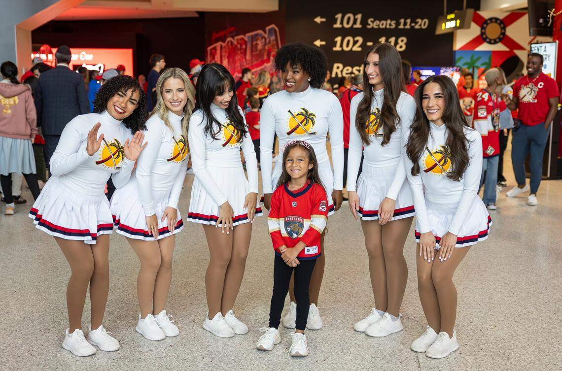 Florida Panthers fan Allison Aguirre, 7, takes a photo with the Florida Panthers Dance Team during a watch party at the Amerant Bank Arena before her team plays against the Edmonton Oilers in Game 1 of the NHL Stanley Cup Final on Wednesday, June 4, 2025, in Sunrise, Fla.