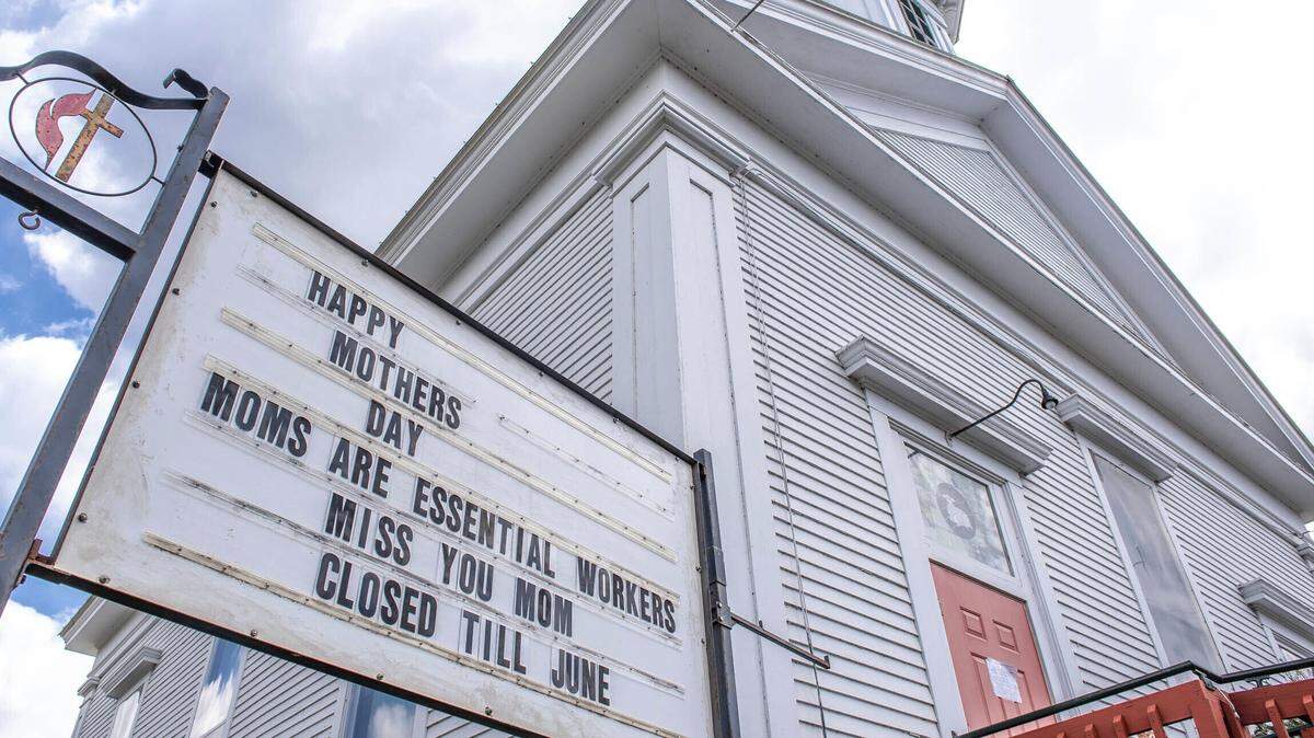 A sign in front of the United Methodist Church in Minot, Maine, reminds passersby of Sunday’s Mother’s Day holiday while giving a nod to the pandemic, Thursday, May 7, 2020.