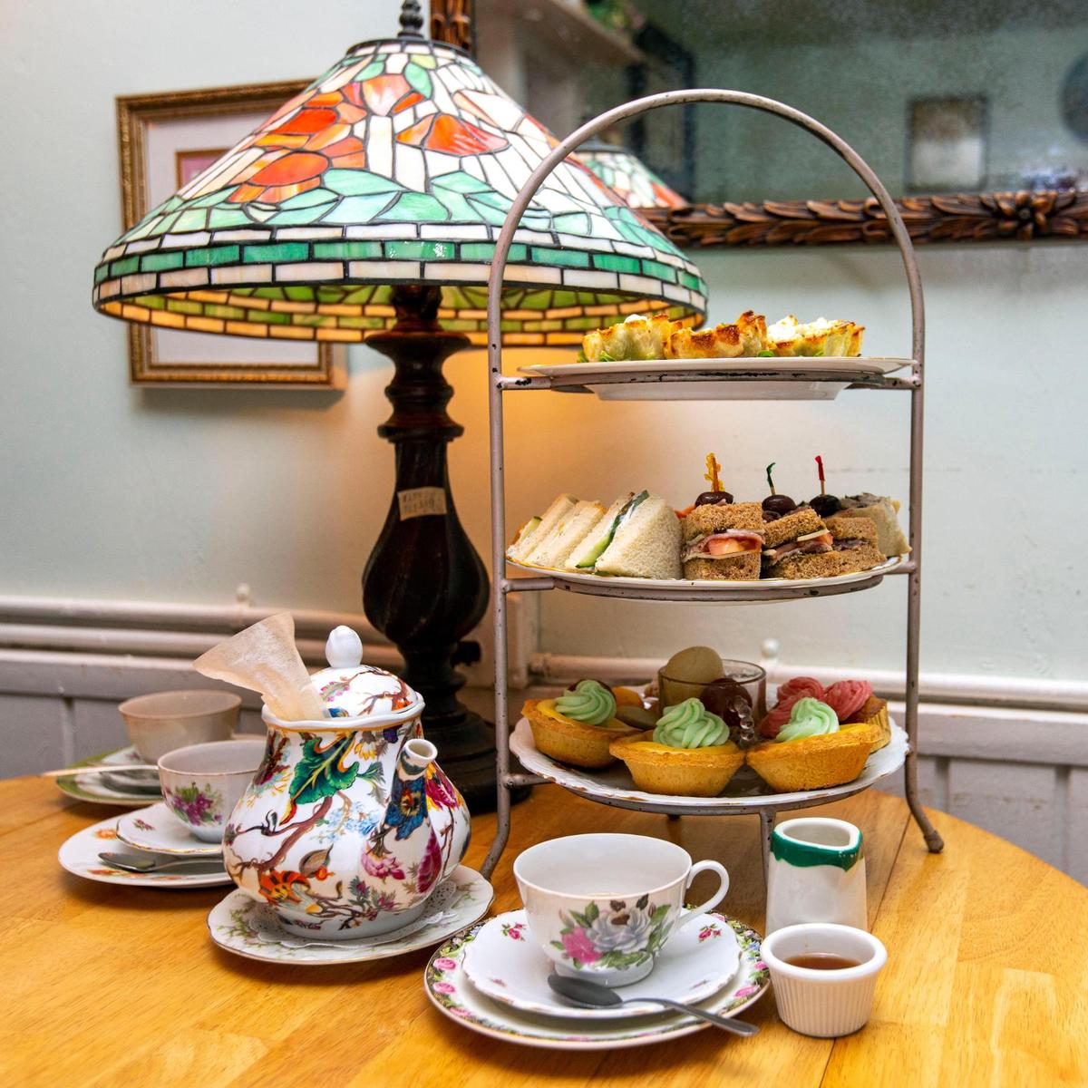 Miniature quiches, scones, sweets, assorted finger sandwiches and tea are part of the ‘High Tea’ menu option inside The Tea Room at Cauley Square in Miami, Florida.