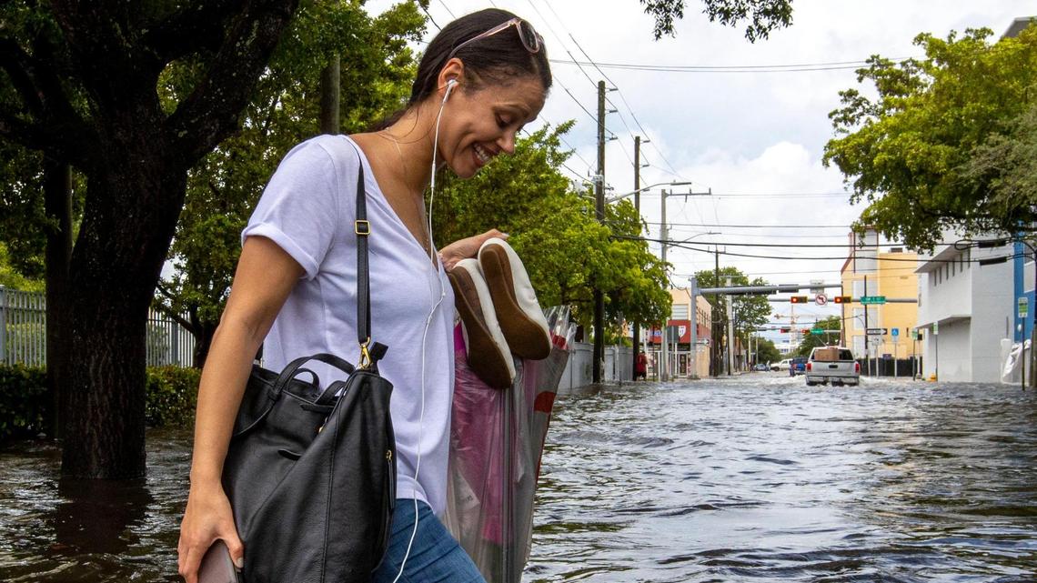 A pedestrian walks through floodwaters on Southwest Second Street in the Little Havana neighborhood of Miami, Florida, on Saturday, June 4, 2022.