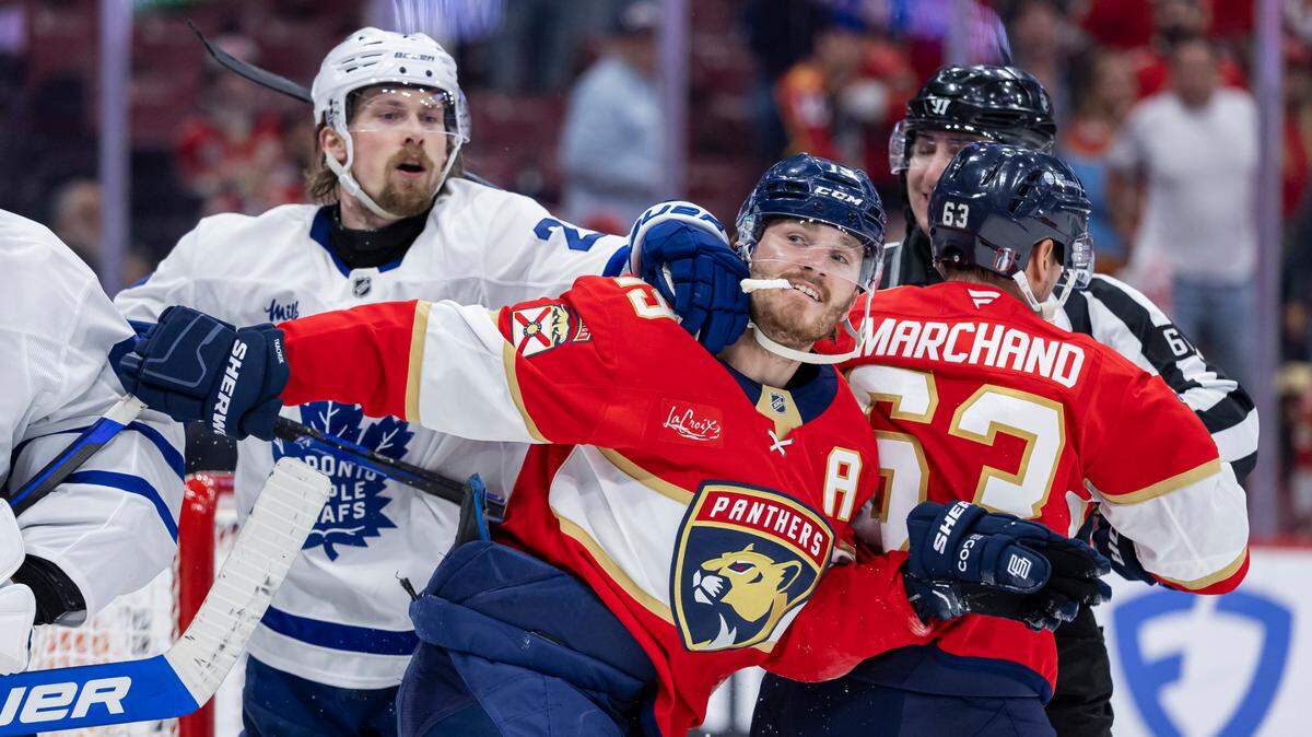 Florida Panthers left wing Matthew Tkachuk (19) and Toronto Maple Leafs defenseman Simon Benoit (2) fight after their Game 6 of a second-round Stanley Cup playoffs series at the Amerant Bank Arena on Friday, May 16, 2025, in Sunrise, Fla. The Panthers lost against the Leafs 2 to 0.