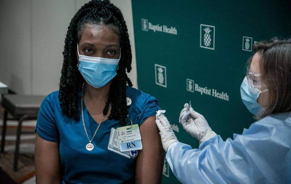 Daphne Pierre, an intensive-care nurse at South Miami Hospital, gets her vaccine in December, when Baptist Health began administering the first COVID-19 vaccines for its front-line healthcare workers
