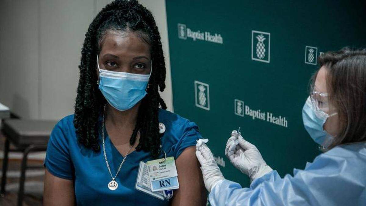 Daphne Pierre, an intensive-care nurse at South Miami Hospital, gets her vaccine in December, when Baptist Health began administering the first COVID-19 vaccines for its front-line healthcare workers