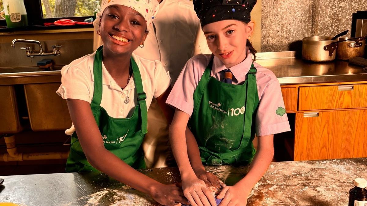 Chef Ignacia Valdes Novik helped Girl Scouts Alejandra Jiménez and Olivia Antillon create fluorescent blue coral-shaped cookies. 