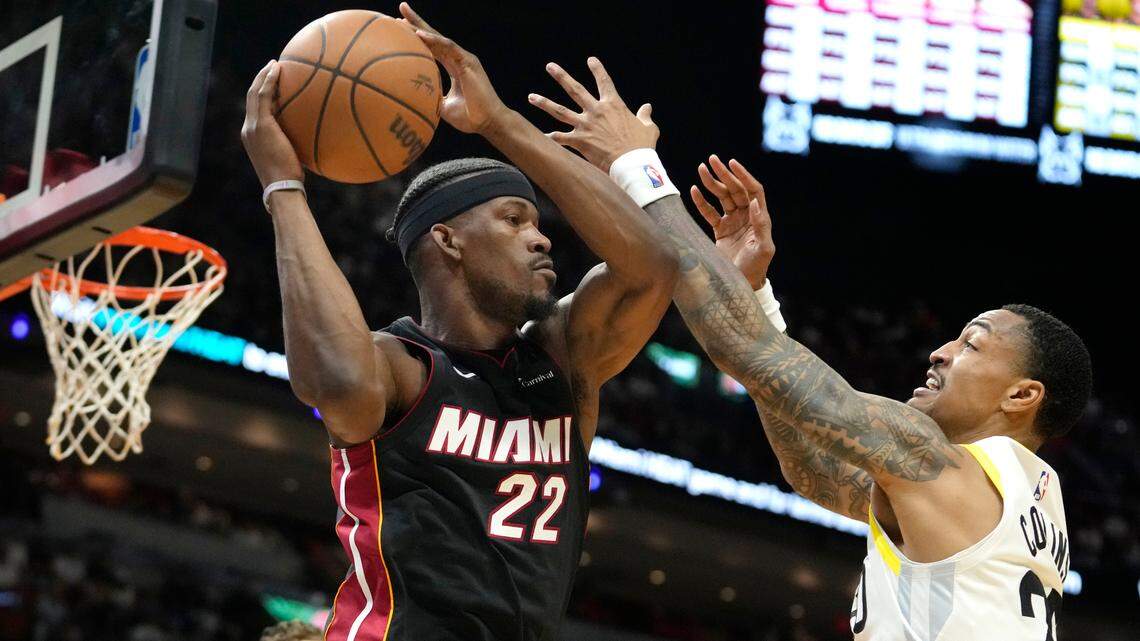 Miami Heat forward Jimmy Butler (22) looks to pass as Utah Jazz forward John Collins (20) defends during the first half of an NBA basketball game, Saturday, March 2, 2024, in Miami.
