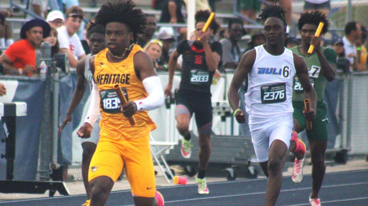 Zamarii Sanders (1835) of Plantation American Heritage runs the anchor leg of the boys 4x100-meter relay as Garry Greggs (2376) of Miami Northwestern pursues during the FHSAA Class 3A high school track and field meet in Jacksonville on May 17, 2024. American Heritage ran 39.39, a state meet record.