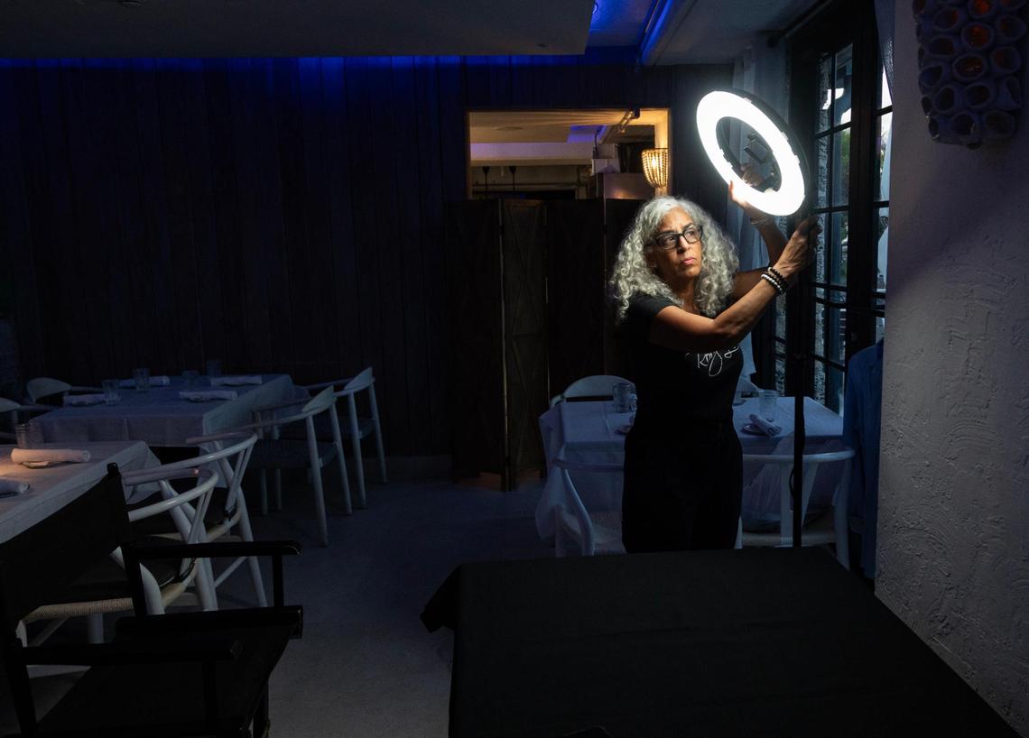 Lee sets up her ring light before laying out her makeup on a table inside NOMA Beach at Redfish before a long commercial shoot for the Herman Agency on July 11, 2023. Lee’s gigs can have a great range in length – she has been on set for five minutes for breaking news shoots and has had shoots last as long as 14 hours. Lee always keeps a kit prepared and ready to go, just in case. She has different sets of brushes for each model or actor on set. “It takes away having to get ready if you always stay ready,” Lee said.