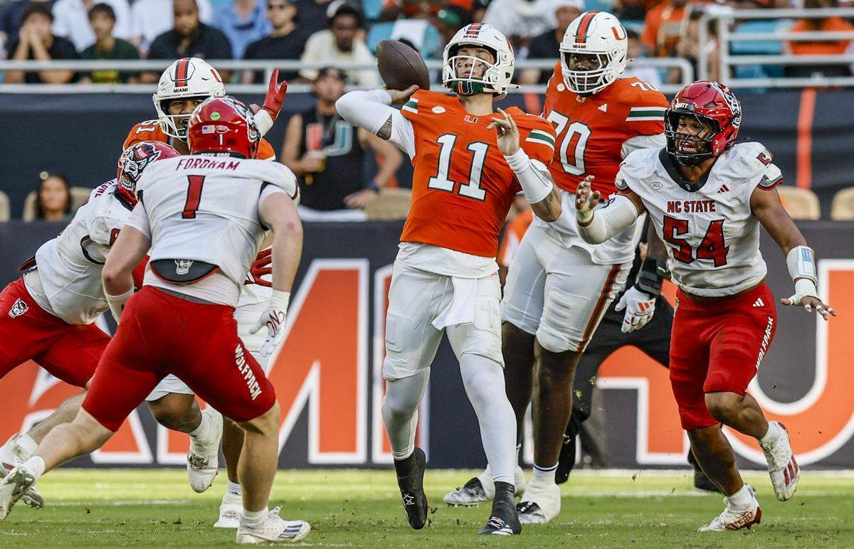 Miami Hurricanes quarterback Carson Beck (11) sets up to pass in the first half of an NFL football game against the NC State Wolfpack at Hard Rock Stadium in Miami Gardens, Florida, on Saturday, November 15, 2025. 