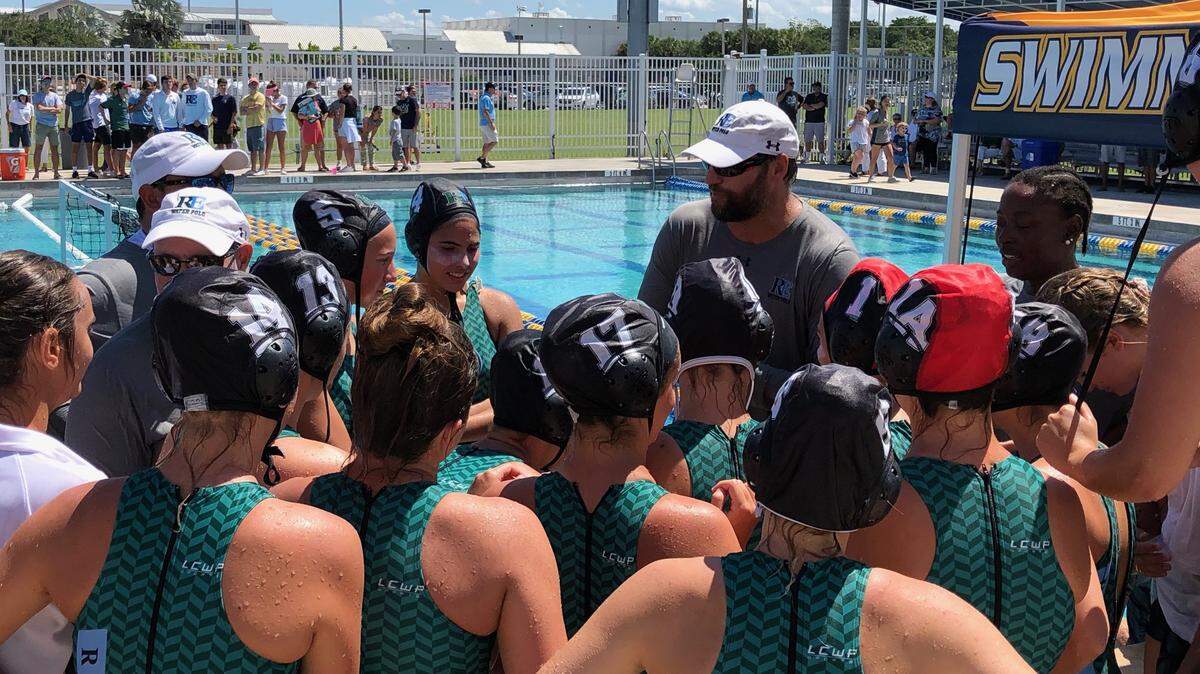 Ransom Everglades girls water polo coach Eric Lefebvre talks to his team following their 11-6 victory over Winter Park on Saturday at Boca Raton High.