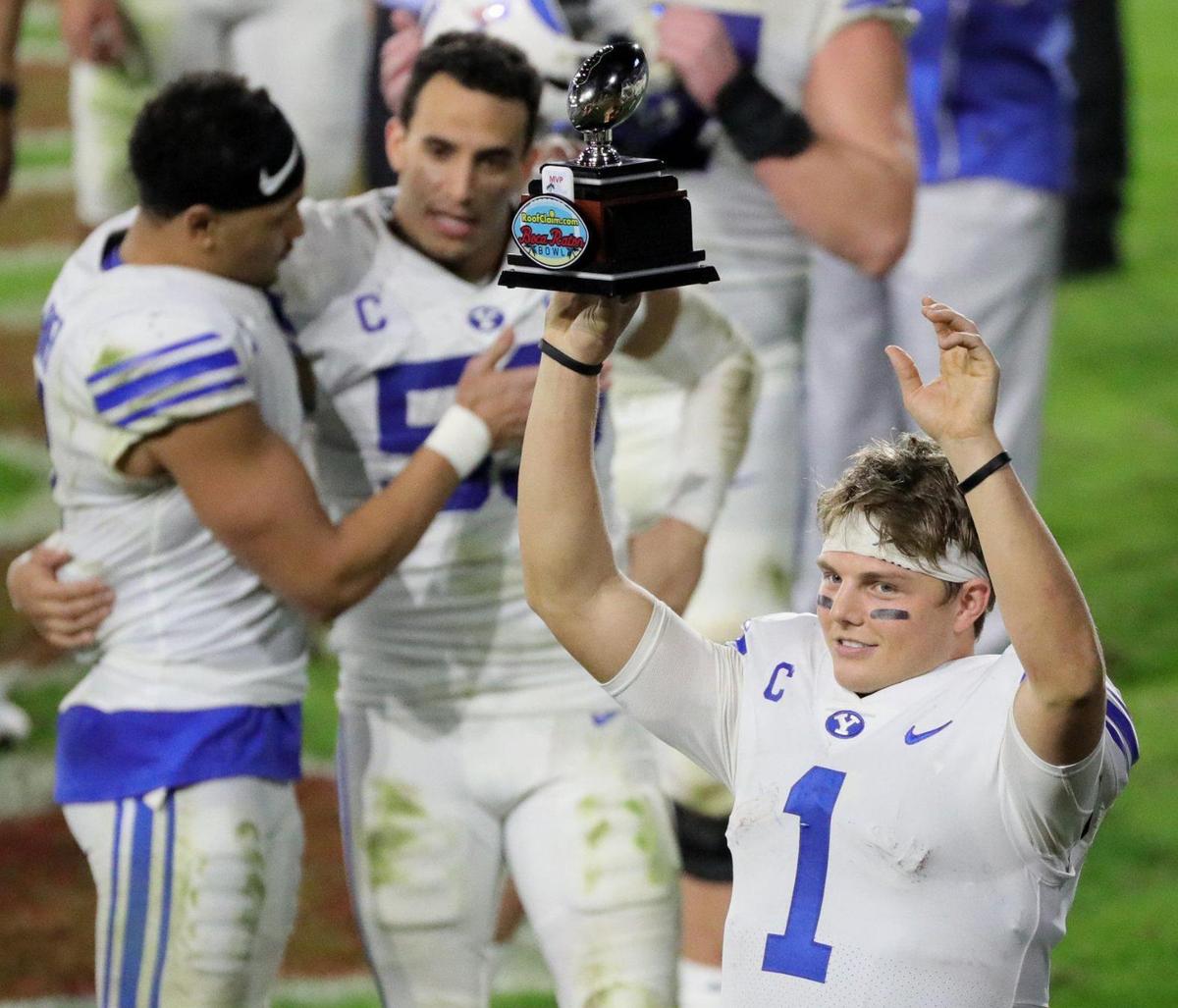 Brigham Young Cougars quarterback Zach Wilson (1) with the MVP trophy after defeating UCF Knights in the Boca Raton Bowl 2020 at FAU Stadium in Boca Raton on Tuesday, December 22, 2020.