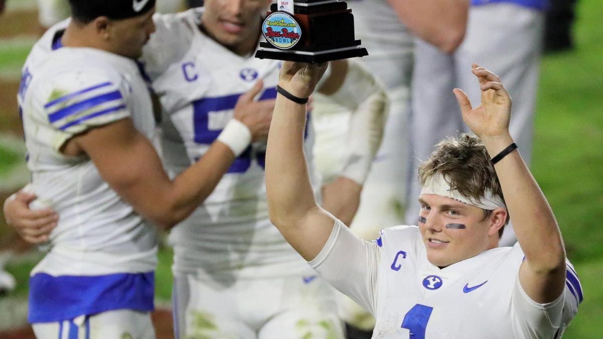 Brigham Young Cougars quarterback Zach Wilson (1) with the MVP trophy after defeating UCF Knights in the Boca Raton Bowl 2020 at FAU Stadium in Boca Raton on Tuesday, December 22, 2020.