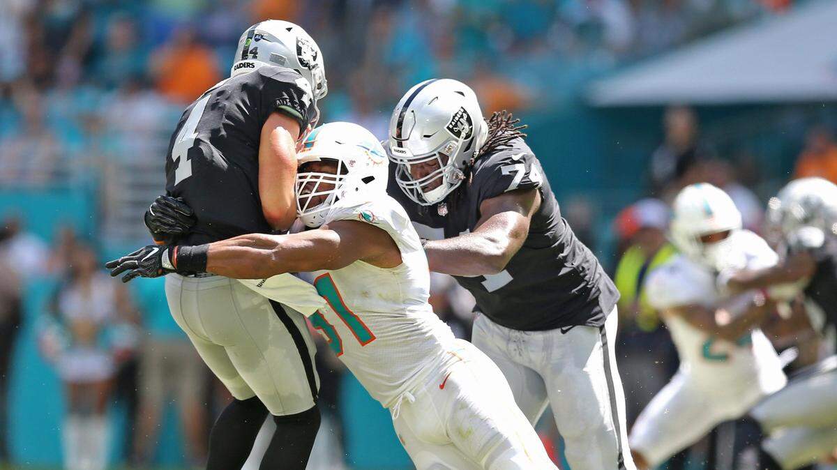 Miami Dolphins defensive end Cameron Wake (91) sacks Oakland Raiders quarterback Derek Carr (4) in the second quarter as the Miami Dolphins host the Oakland Raiders at Hard Rock Stadium in Miami Gardens on Sunday, September 23, 2018.