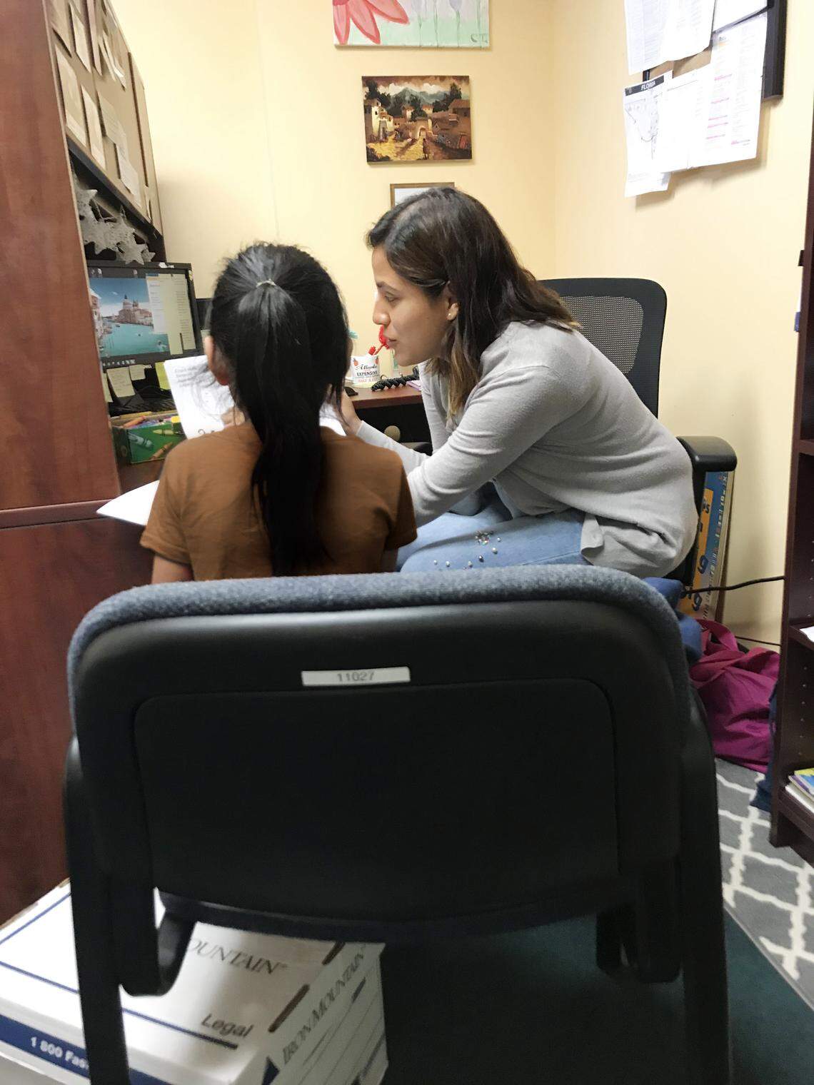 Americans for Immigrant Justice paralegal Cindy Torres meeting with one of the migrant children the legal aid organization represents.