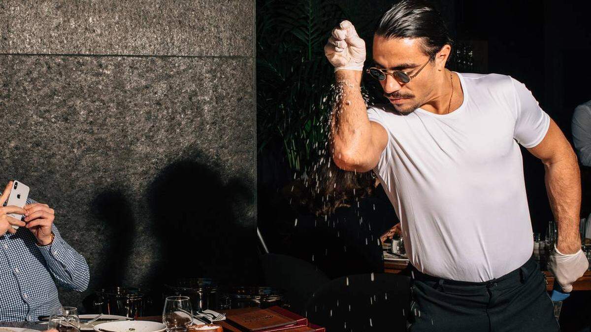 Salt Bae serves his steak with a famous flourish at his Manhattan restaurant.