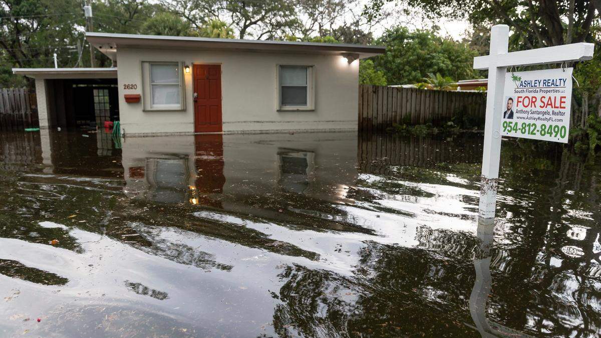 A property that is for sale is seen partially submerged in the Edgewood neighborhood on Thursday, April 13, 2023, in Fort Lauderdale, Fla. A torrential downpour severely flooded streets partially submerging houses and cars across South Florida.