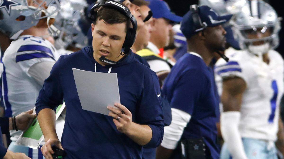 Dallas Cowboys offensive coordinator Kellen Moore walks the sidelines during an NFL wild-card playoff football game against the San Francisco 49ers in Arlington, Texas, Sunday, Jan. 16, 2022. The 49ers won 23-17. (AP Photo/Ron Jenkins)