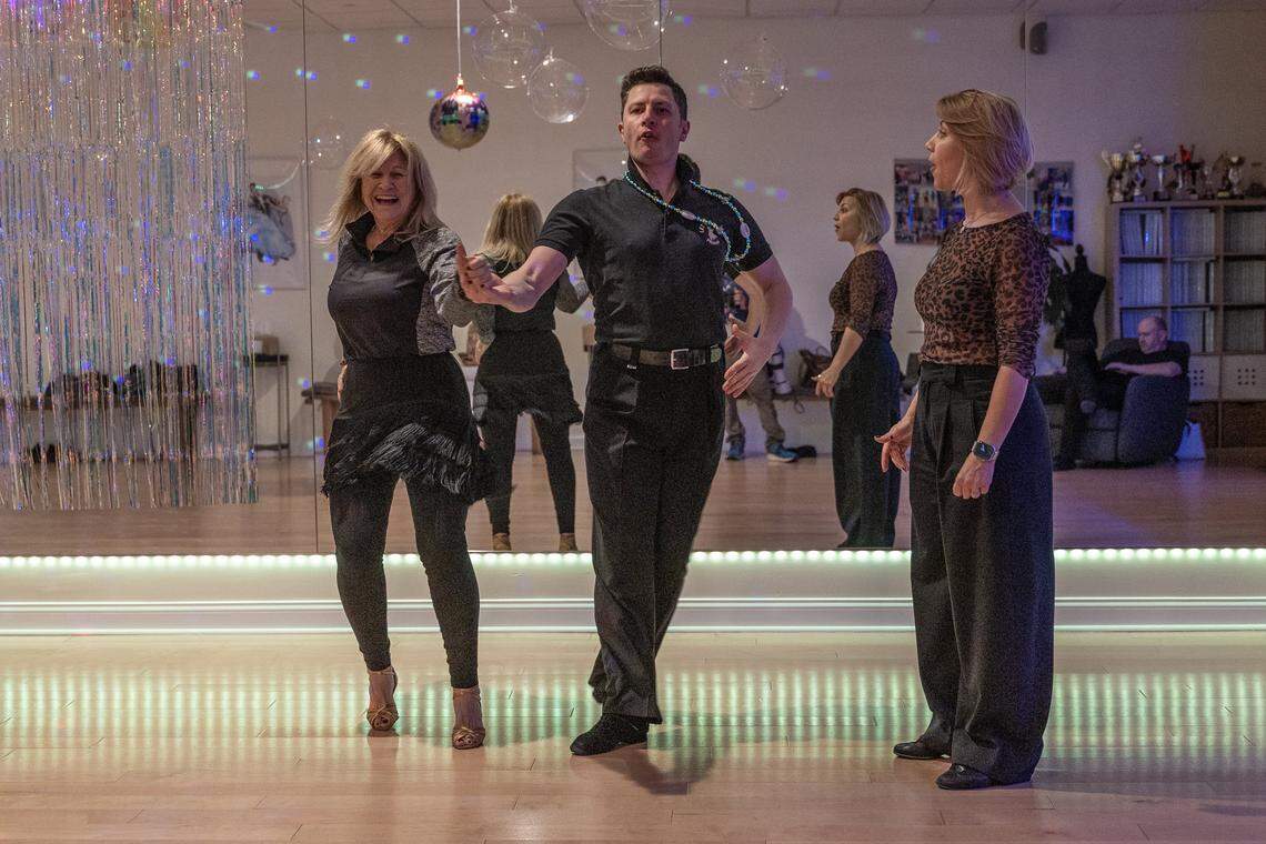 Student Xiomara Torrens (far left) dances with instructor Stefan Ilies as instructor Ksenia Kasper looks on, during a class at Let's Dance Miami studio in Aventura, on Wednesday, February 18, 2026.