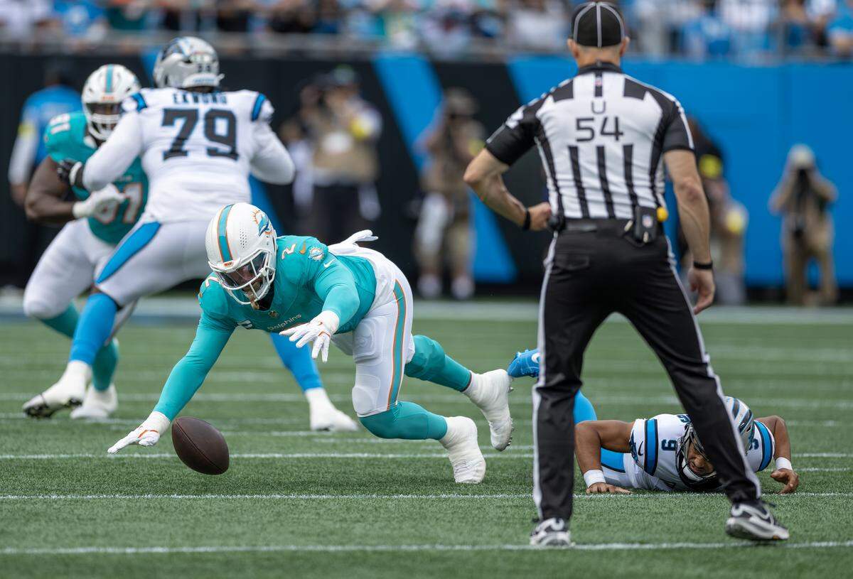 Miami Dolphins outside linebacker Bradley Chubb (2) recovers a fumble by Carolina Panthers quarterback Bryce Young (9) in the first half of their NFL game at the Bank of America Stadium on Sunday, Oct. 5, 2025, in Charlotte, N.C.
