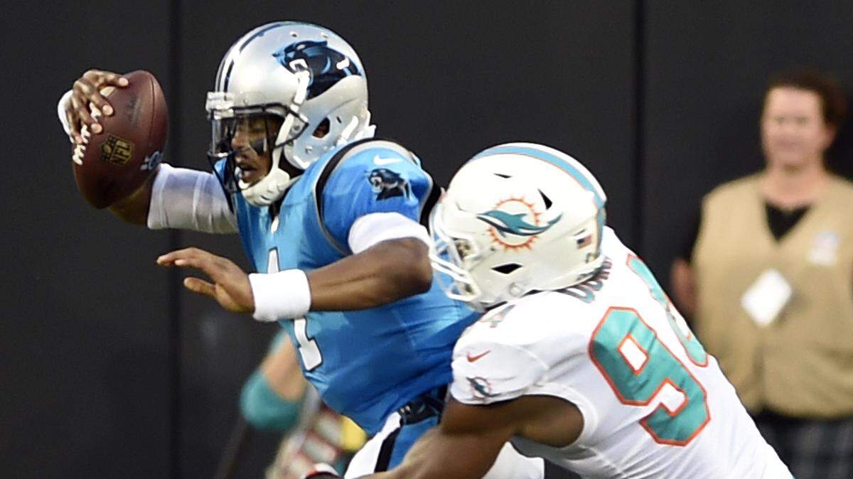 Carolina Panthers’ Cam Newton (1) is sacked by Miami Dolphins’ Robert Quinn (94) in the first half of a preseason NFL football game in Charlotte, N.C., Friday, Aug. 17, 2018.