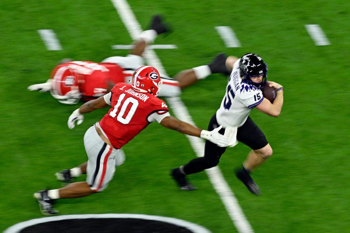 Jan 9, 2023; Inglewood, CA, USA; TCU Horned Frogs quarterback Max Duggan (15) runs against Georgia Bulldogs linebacker Jamon Dumas-Johnson (10) in the third quarter in the CFP national championship game at SoFi Stadium. Mandatory Credit: Robert Hanashiro-USA TODAY Sports