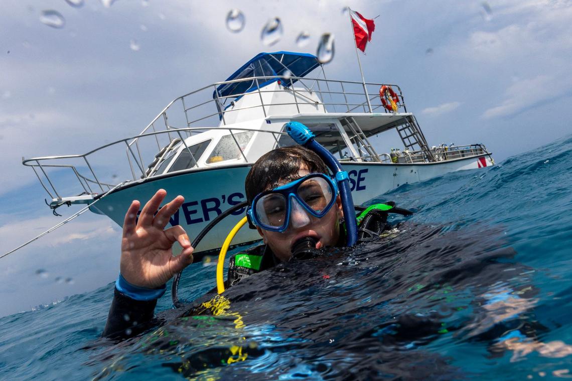 Master Diver Matteo Miller, 12, makes an ‘OK’ gesture during an ocean dive session on Friday, August 9, 2024, in Key Biscayne, Fla. Miller received the Master Diver certification after completing his Rescue diver certification.