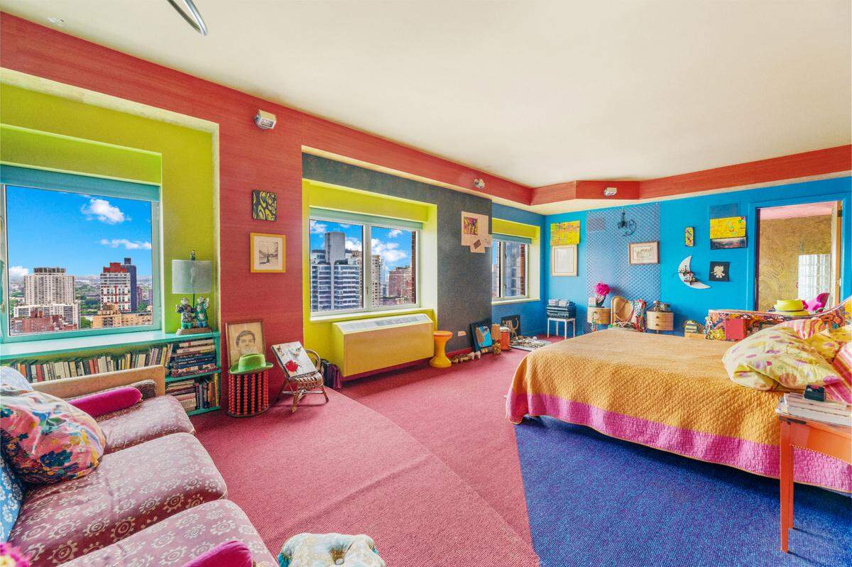The primary bedroom of arguably the happiest and most colorful home for sale in New York City.