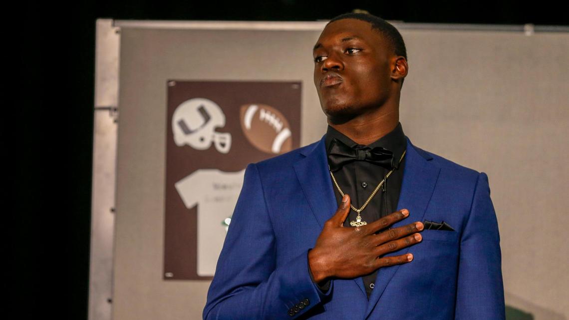 Miami Central High School linebacker Wesley Bissainthe reacts prior signing his letter of intent to play college football for the Canes at the University of Miami during a ceremony at the Miami Central High School auditorium on Wednesday, December 15, 2021