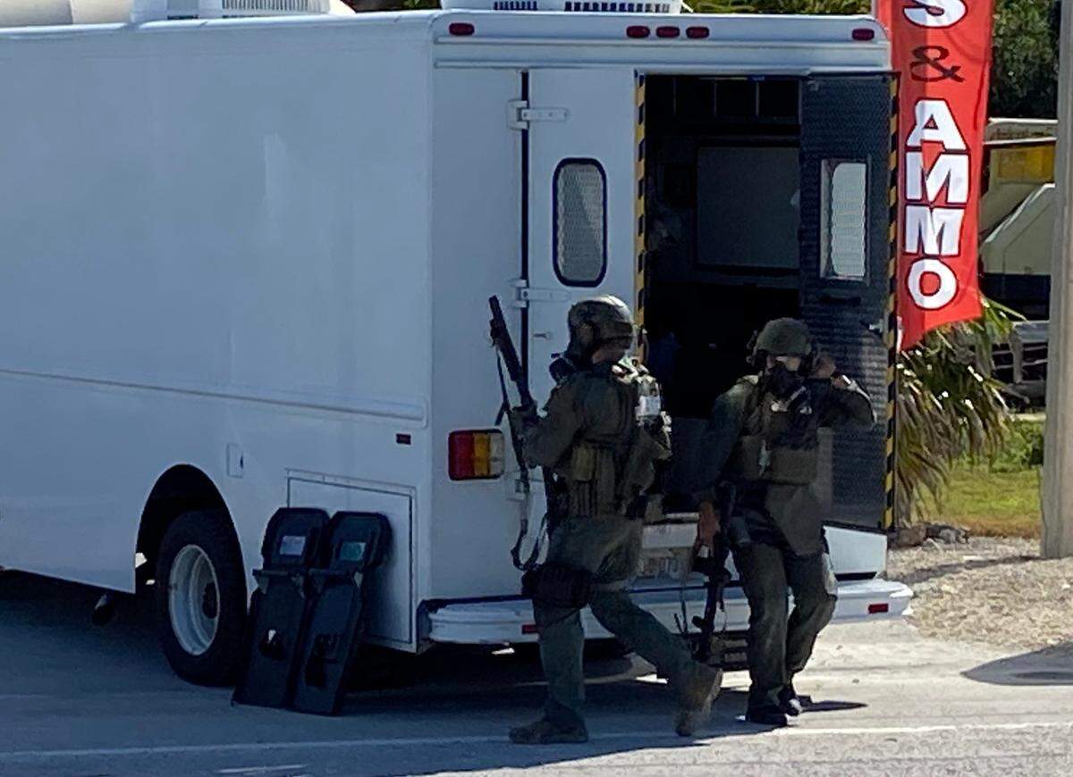 Members of the Monroe County Sheriff’s Office tactical team arrive outside a pawn shop on U.S. 1 on Thursday, Jan. 7, 2021. An armed man was barricaded in a trailer behind the shop.