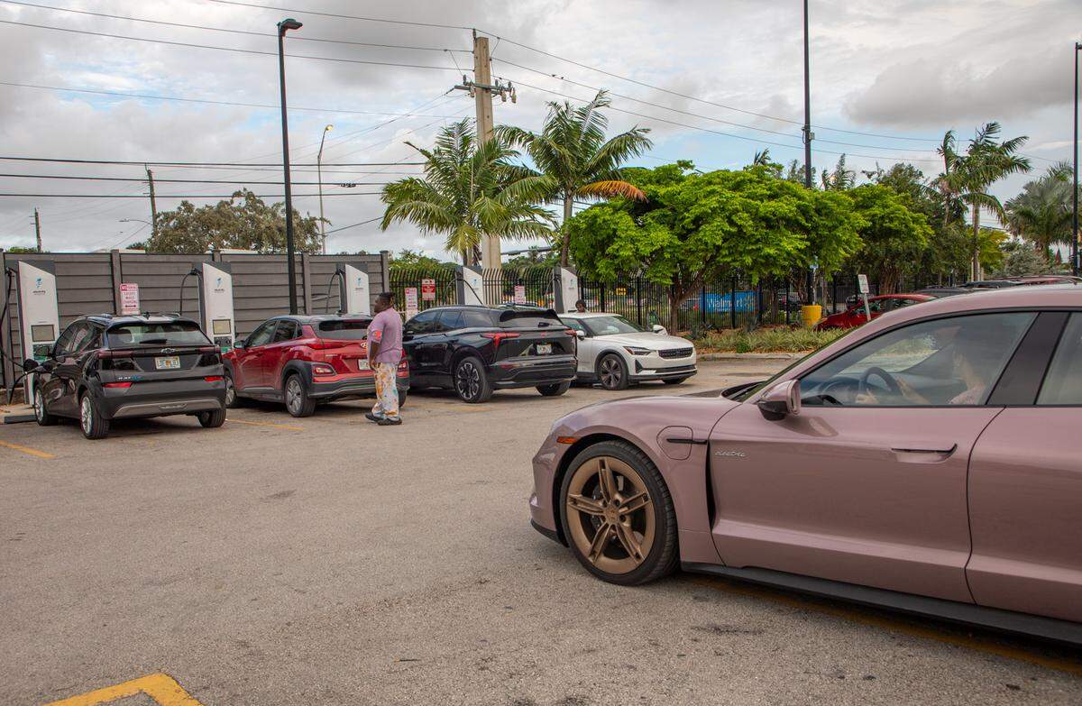 An EV driver waits in her car for a charger to open up at the Hialeah Walmart.