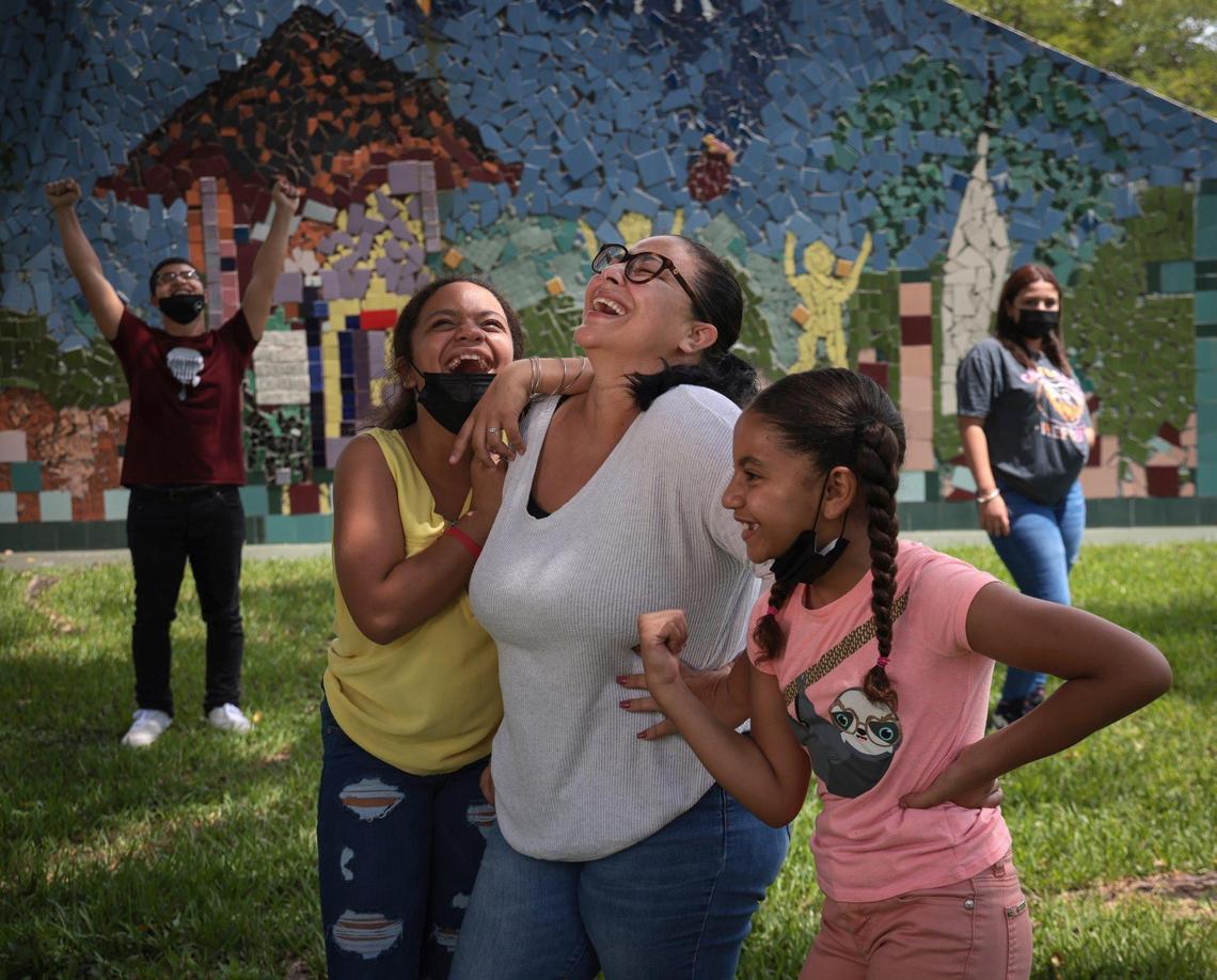 Caridad Galastica, center, breaks into laughter as she recalls overcoming the fear of needles to get her Pfizer COVID-19 vaccine. She said that the safety of her children was one of her main concerns. Galastica and her children Angel Padilla, 17, left, Alexandra Galastica, 11, Alexis Galastica, 10, and Jusett Laura, 14, right, were photographed at Tropical Park on Sunday, Sept. 12, 2021.