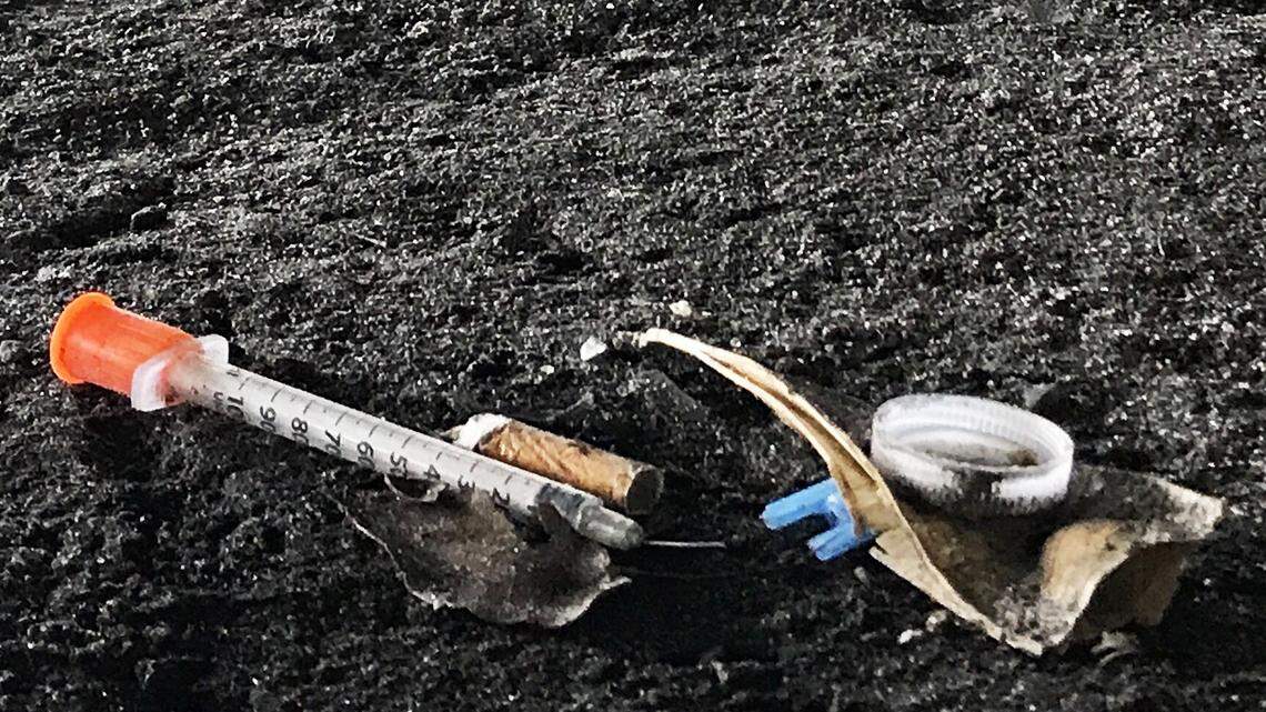 Discarded hypodermic needles are scattered under an 836 overpass in Overtown.