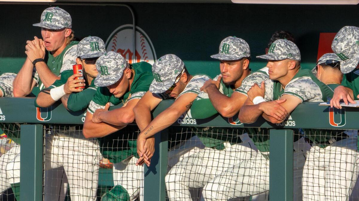 Hurricanes players look on from the dugout in the bottom of the fourth inning of Miami’s Coral Gables Regional game versus the University of Texas at Mark Light Field on June 4, 2023.